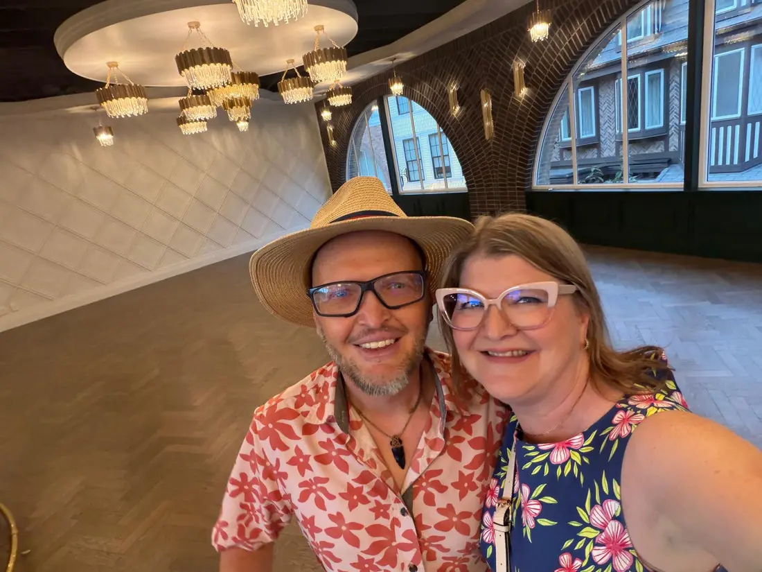 Salsa Paul in his straw hat posing with a guest in the empty ballroom before doors