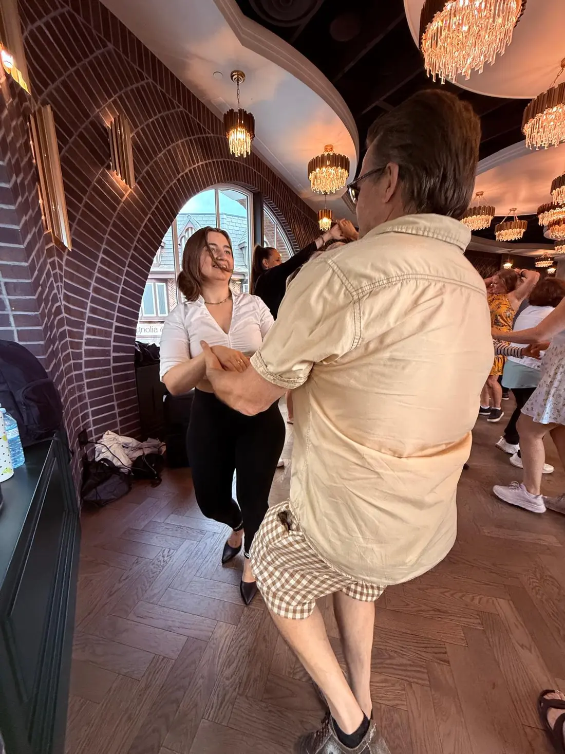 A pair working through an underarm turn on the herringbone floor