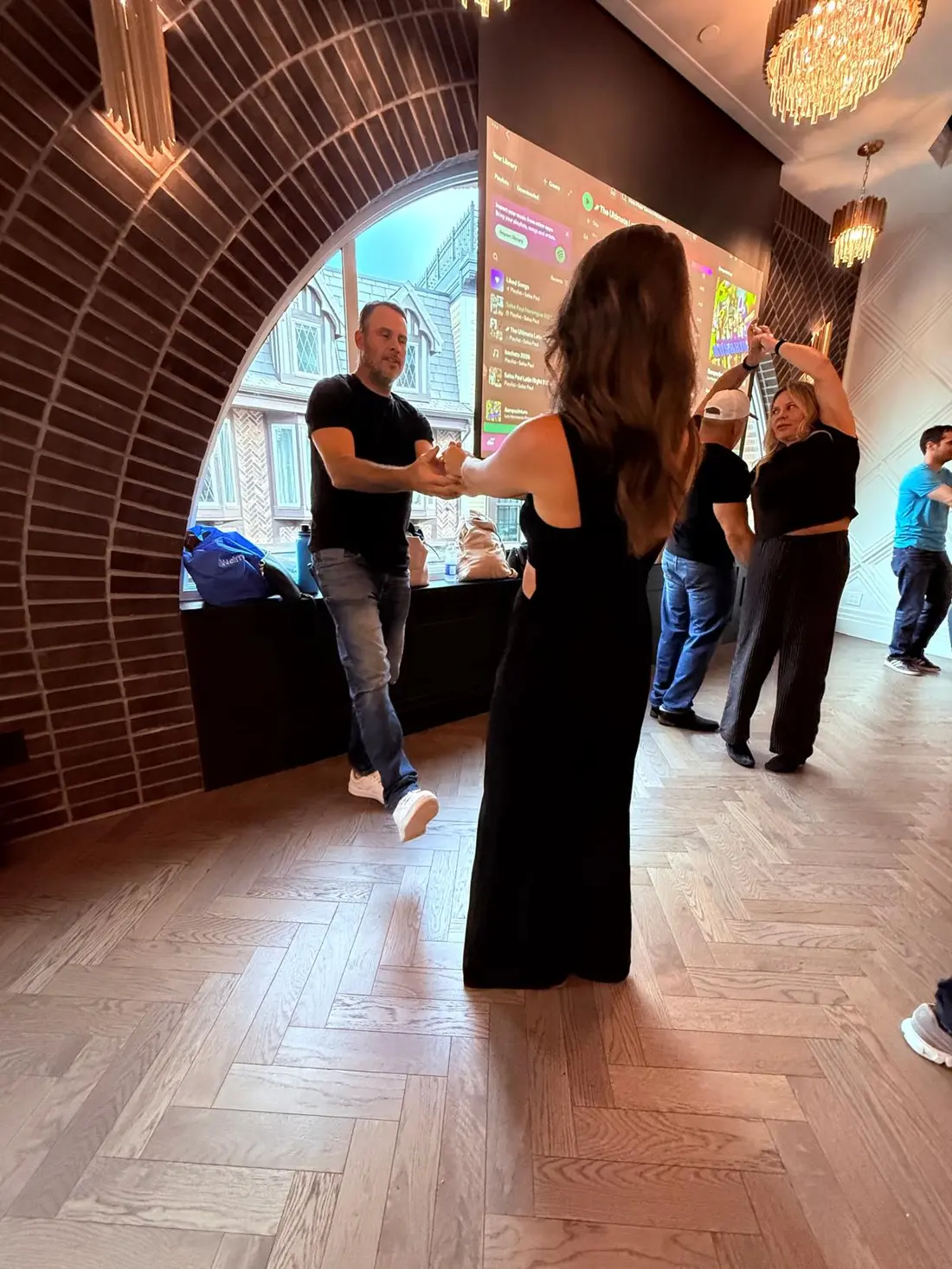 A pair smiling through a hand-to-hand pattern on a full floor