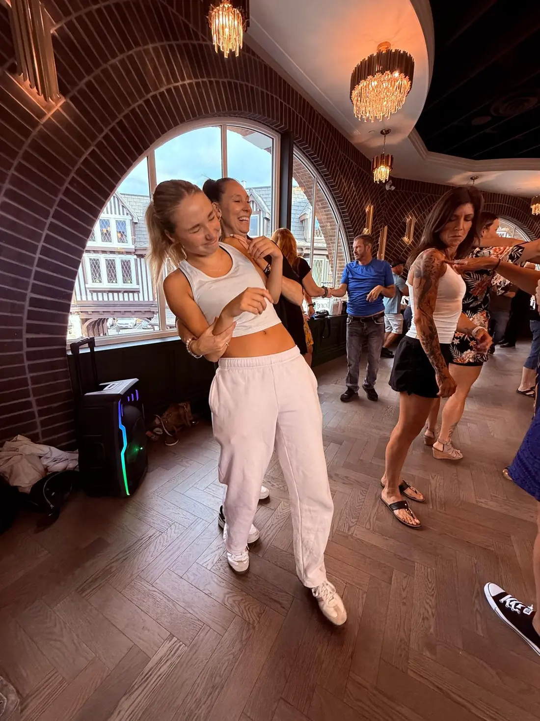 Two young dancers practising a hand-to-hand pattern by the window