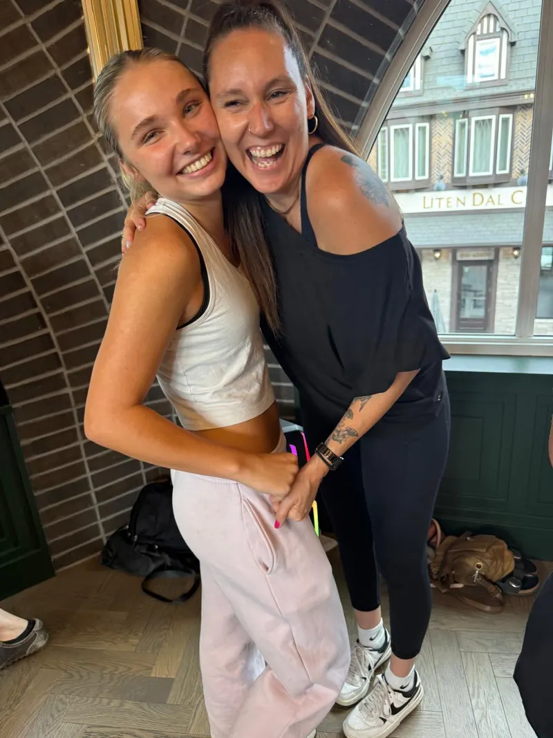 Two dancers laughing cheek to cheek after a beginner salsa lesson at The Grand Hall in Chilliwack