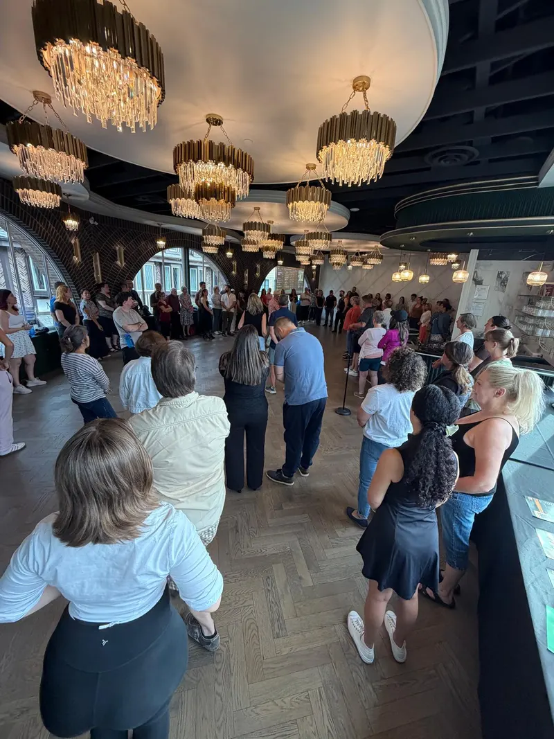Dancers gathered in a wide circle at The Grand Hall in Chilliwack, listening to instructor Salsa Paul before the lesson begins